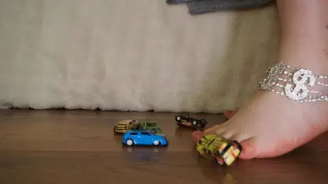 #6 Giant goddess plays with small cars